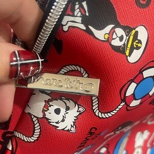 Marc Tetro Red Cosmetic Bag with Playful Dog Design
